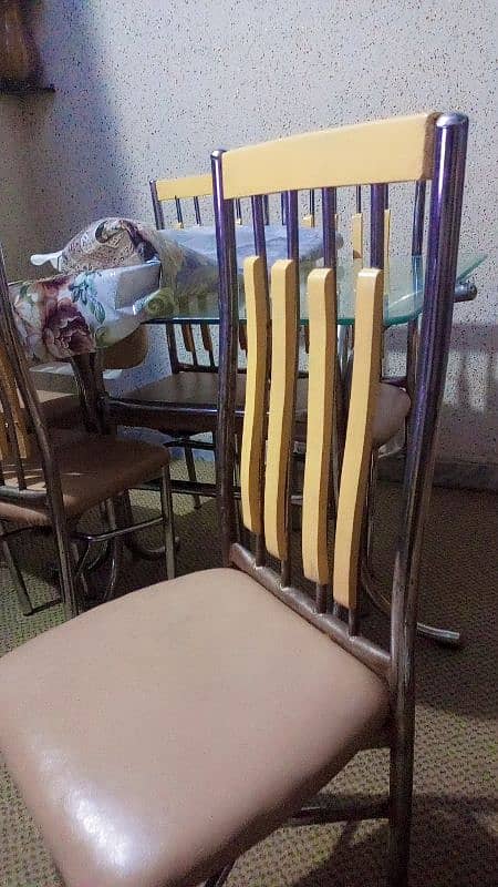 Glass table with six chairs in good condition 0