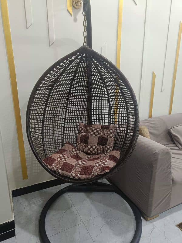 Swing chair with iron stand and cousins. 0