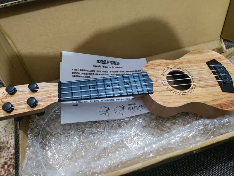 New small Ukulele with Box and pick 3