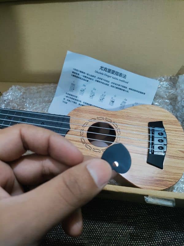 New small Ukulele with Box and pick 4