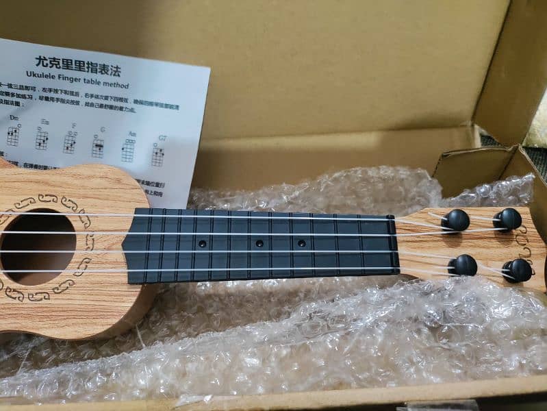 New small Ukulele with Box and pick 8