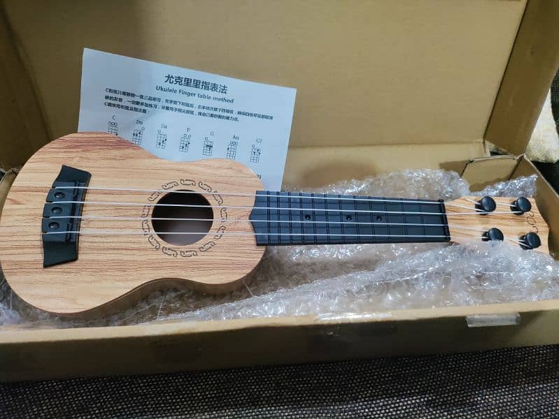 New small Ukulele with Box and pick 11