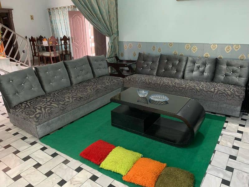 grey velvet sofa with black centre table 0