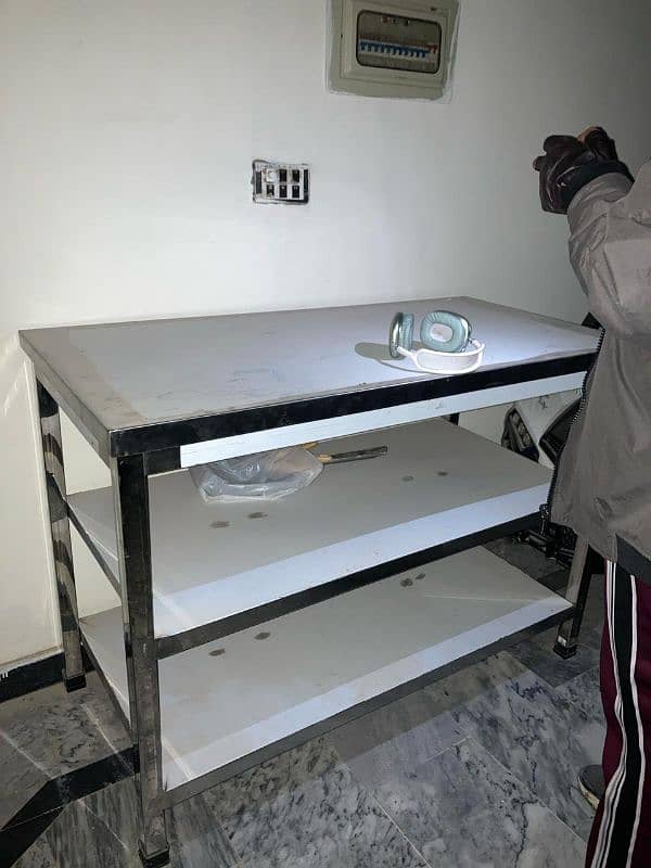 Stainless steel table with 2 compartments. 1