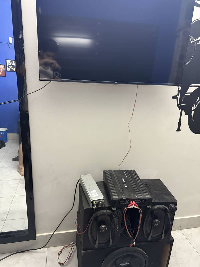 A complete set of car woofer and speakers with supply attached with tv 1