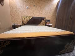 bed with side table and metrress