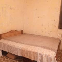 wooden bed and dressing table