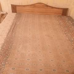wooden bed and dressing table
