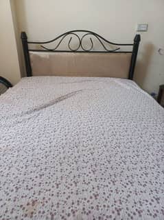 single iron bed & wooden cabinet