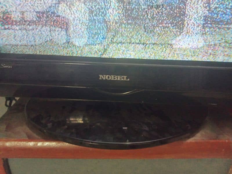 A wooden bed and dressing with side tables Nobel TV 7