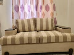 Two seater beige sofa