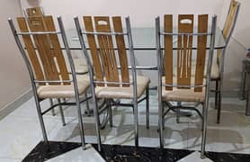 Glass top dining table with chairs