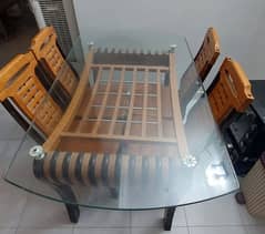 wooden table with glass top with 4 chairs