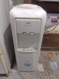 Water dispenser for sale in good condition with attached refrigerator.