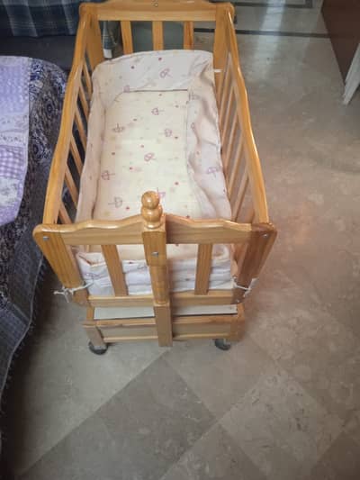 baby bed with two drawers under it  and with mosquito net on top