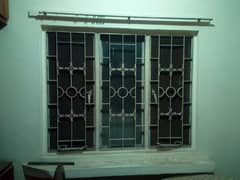 iron windows with security grill and glass