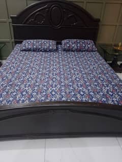 wooden bed with dressing