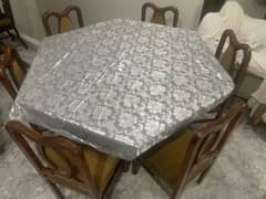 A dining table with 6 chairs.
