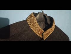 Groom's black and gold sherwani