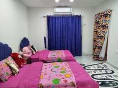 Two single beds with curtains and dressing table