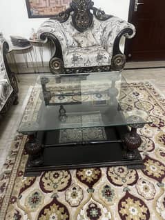Elegant Glass Top center table with carved wooden base