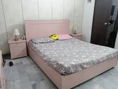 Queen size bed set with side tables and dressing table with mirror.