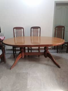 A wooden dinning table with 6 wooden chairs
