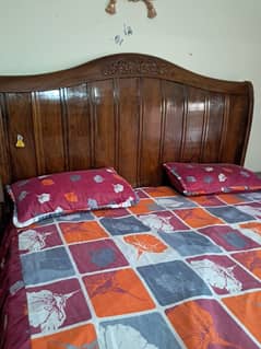 bed with 2 side table and dressing