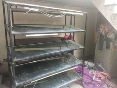 two iron frame and glass racks shoe racks