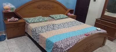 King size wooden bed with sight board