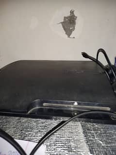 ps3 slim console with 2 wireless controller on it