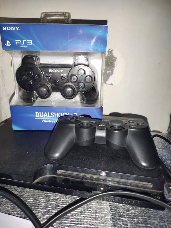 ps3 slim console with 2 wireless controller on it 1