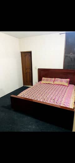 Room with attached washroom double bed mattress and ceiling