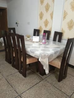 8 chairs with dining table in good condition in wood.
