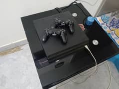 ps4 pro 1 tb console with two controllers and monitor
