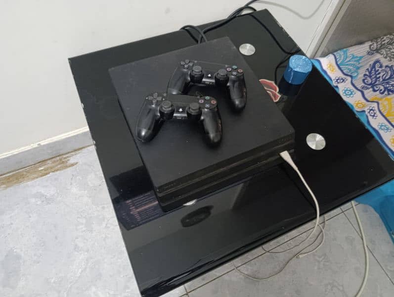 ps4 pro 1 tb console with two controllers and monitor 0
