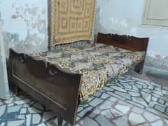 2 wooden single beds