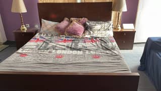 King size bed with two side tables with glass top