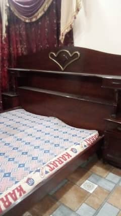 one bed without mattress with two side tables