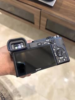 Sony A6400 body with 56mm 1.2 lens and Godox flash
