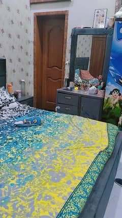 bed with dressind and side table