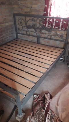iron double bed with two sude tables