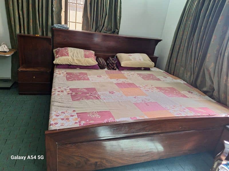 king bed with mattress along with side table and dressing table 0