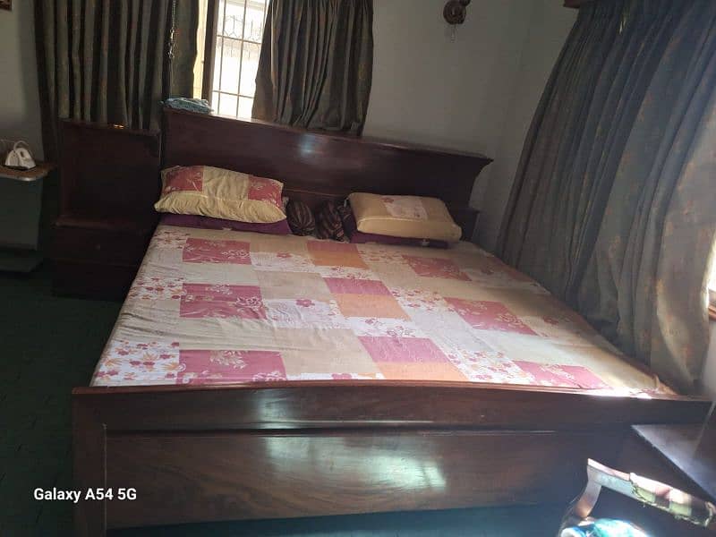 king bed with mattress along with side table and dressing table 3