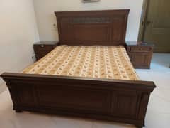Wooden bed without mattress and dressing table