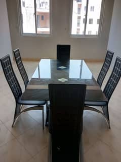 Thick glass table with 6 chairs.  In very good condition.