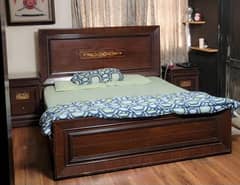wooden bed and dressing table