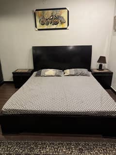 Solid bed with side table