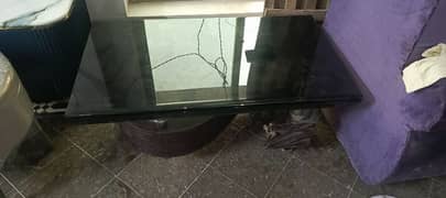 the upper part of table is glass and the lower part is wood