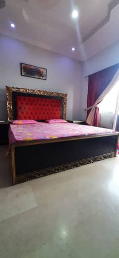 king size bed with side table and chairs